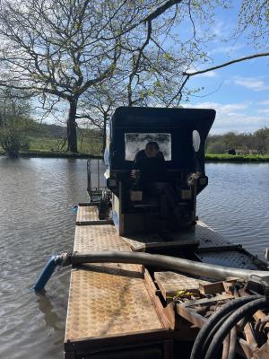 Carefully part de-silting the swimming pond
